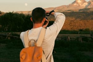 A man is taking a picture with his cell phone