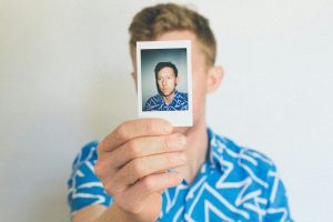 man showing photo of him